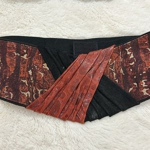 Black belt with coral suede and leather front detail, adjustable elastic back.